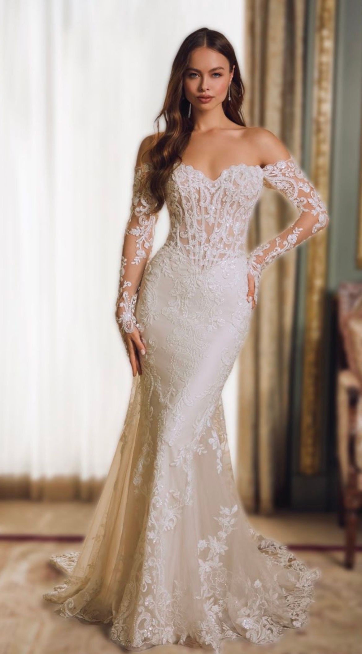 Blonde woman in strapless lace wedding dress, smiling, indoors.