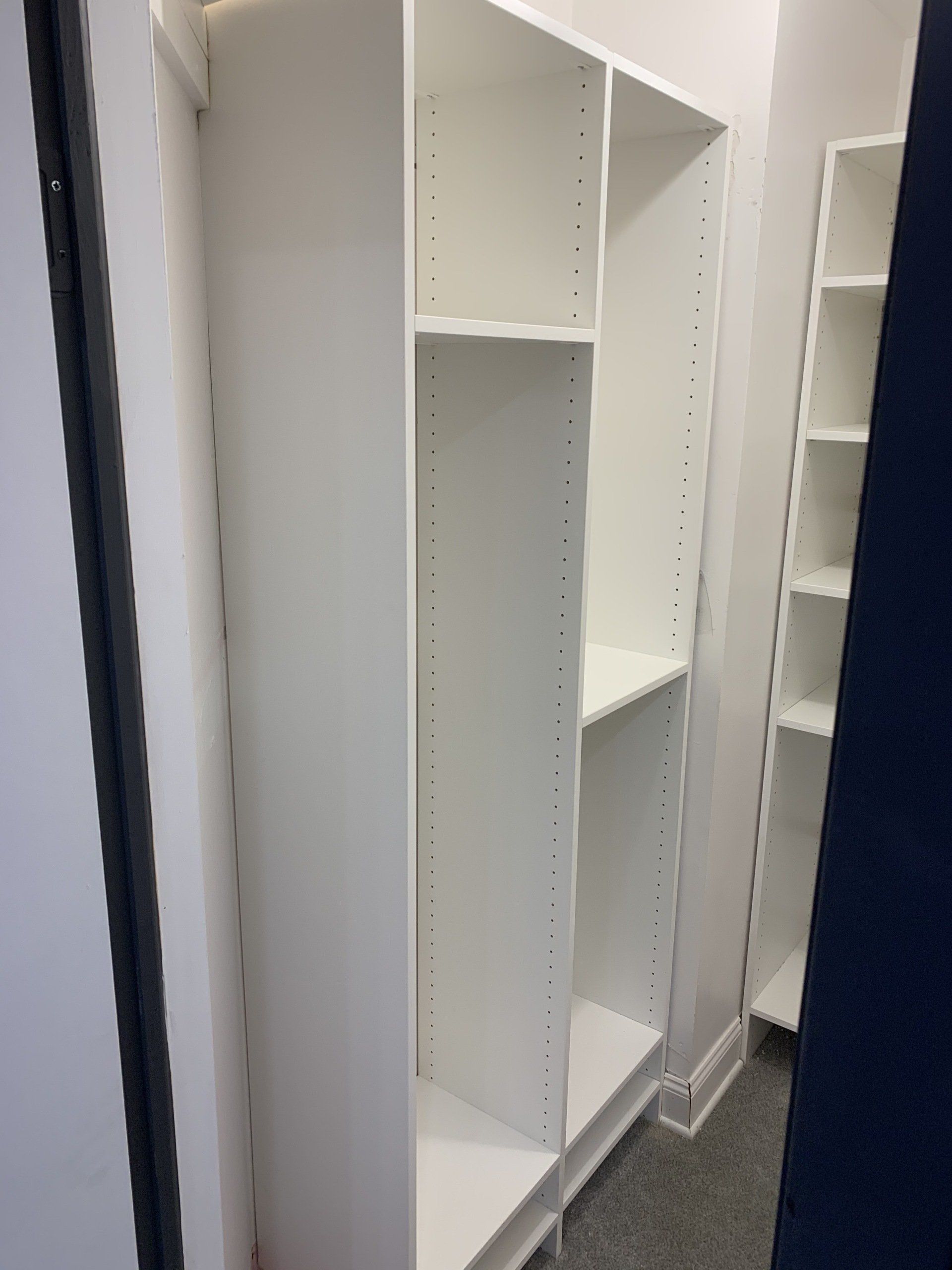 White closet shelving unit installed inside a room.