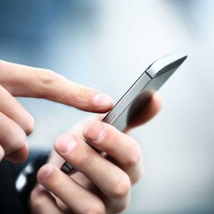 Close up of a man using mobile smart phone
