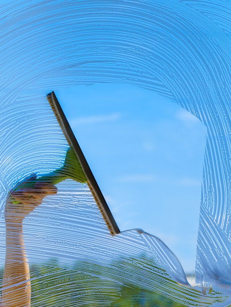 Removing the Glass Cleaner with a Squeegee — Highlands Window Cleaning in Mittagong, NSW