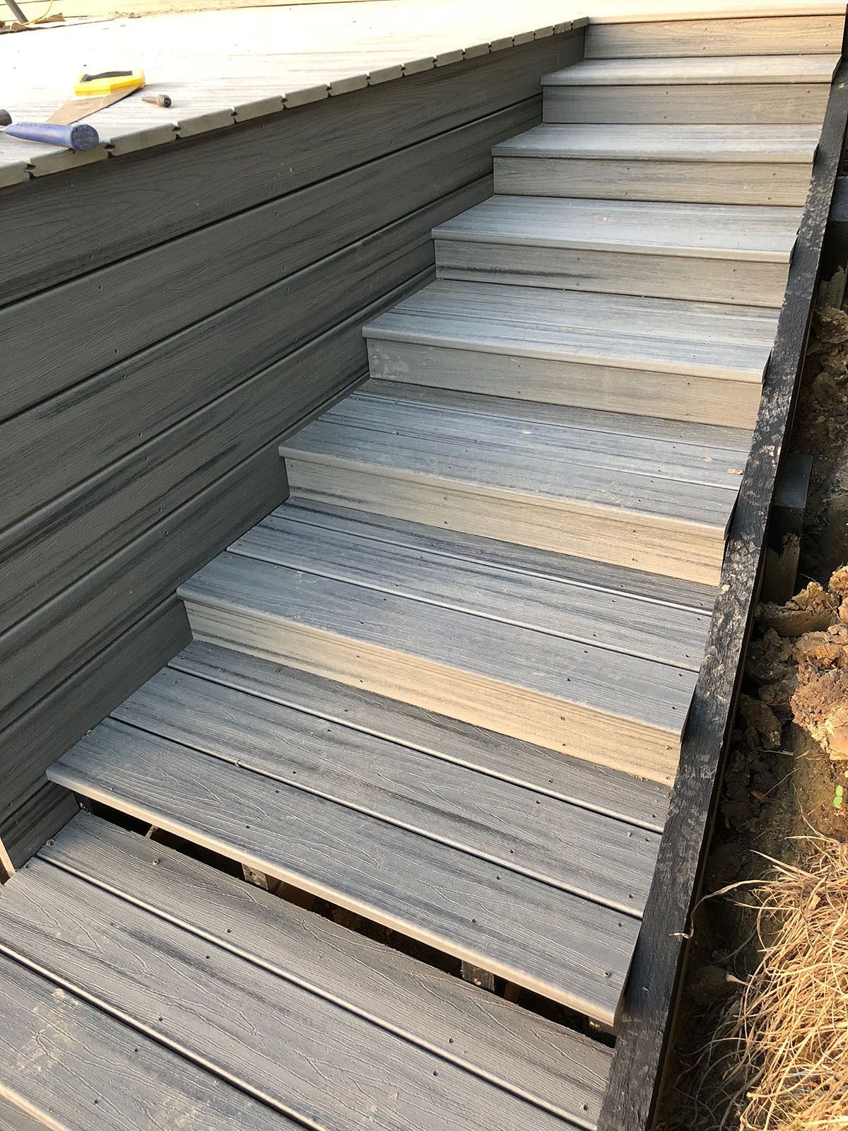 A set of wooden stairs leading up to a deck.