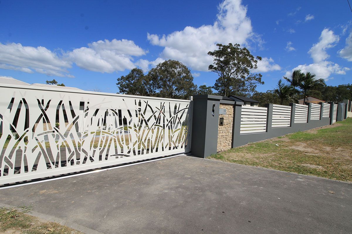 A white fence with a geometric design on it