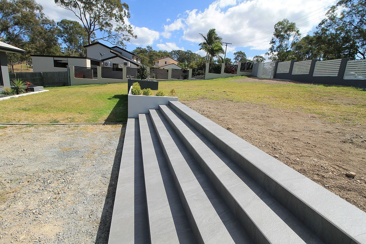 A set of stairs leading up to a grassy field