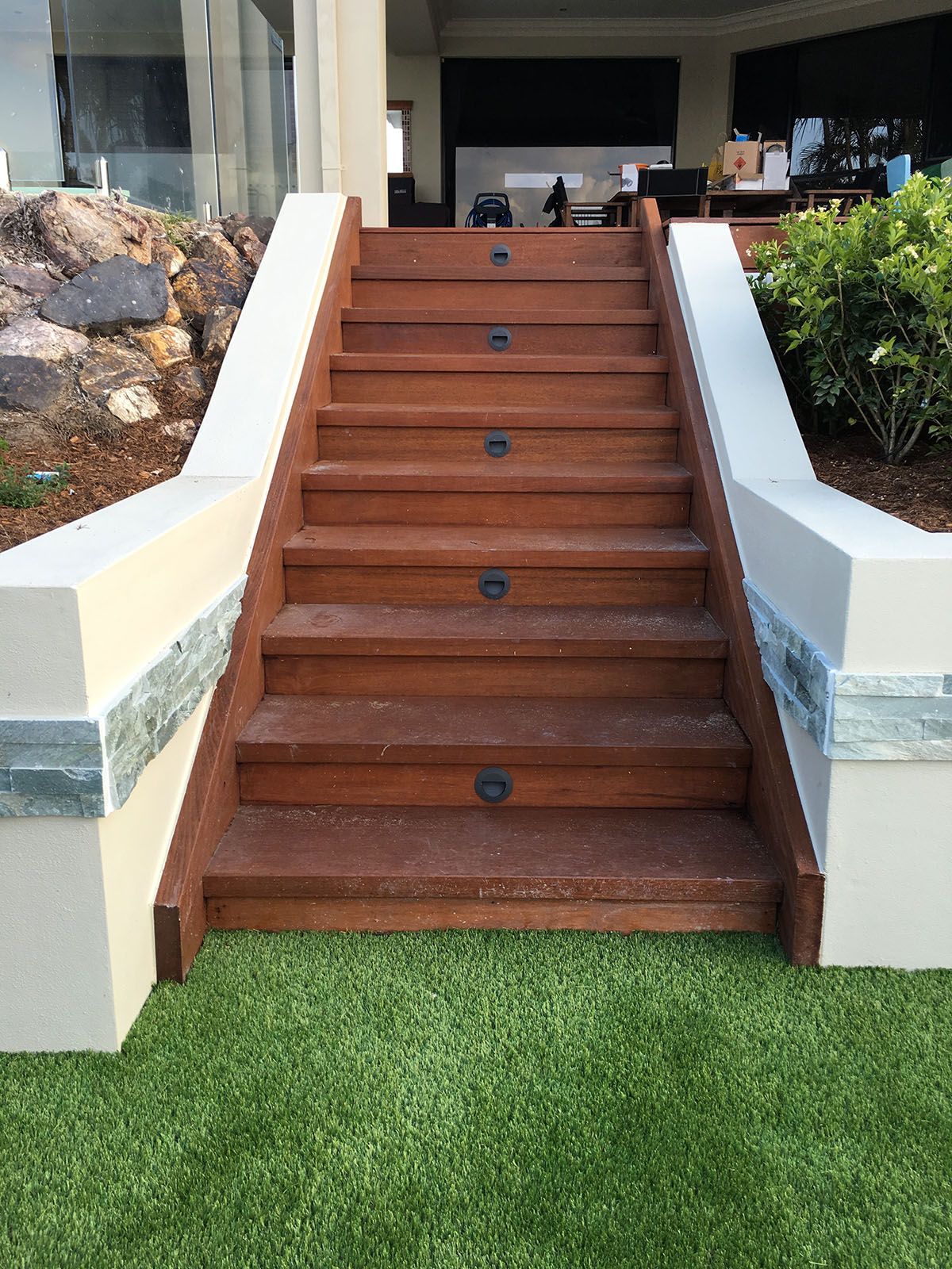 A set of wooden stairs leading up to a house.