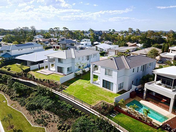 An aerial view of a residential area with houses and a pool.