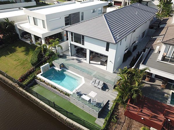 An aerial view of a house with a pool in the backyard.