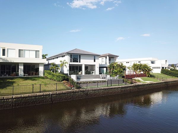 An aerial view of a row of houses next to a body of water.