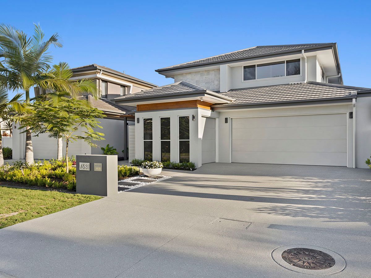 A large white house with a garage and a driveway