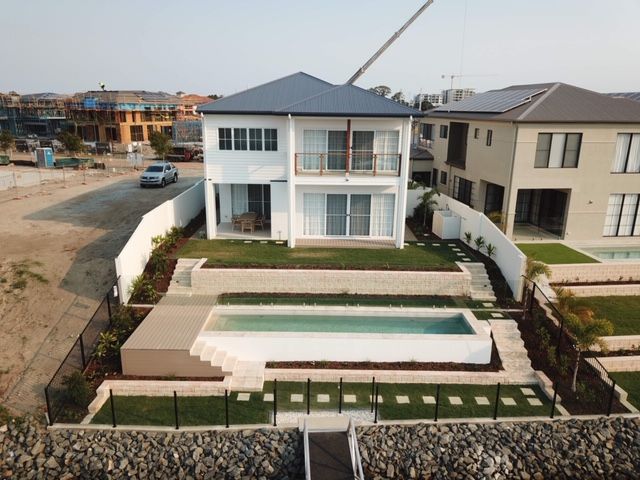 An aerial view of a house with a swimming pool