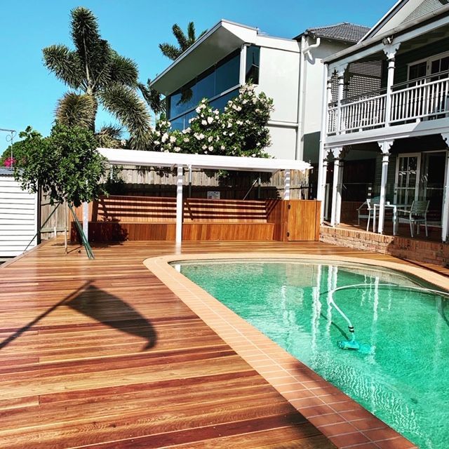 A large house with a swimming pool in front of it