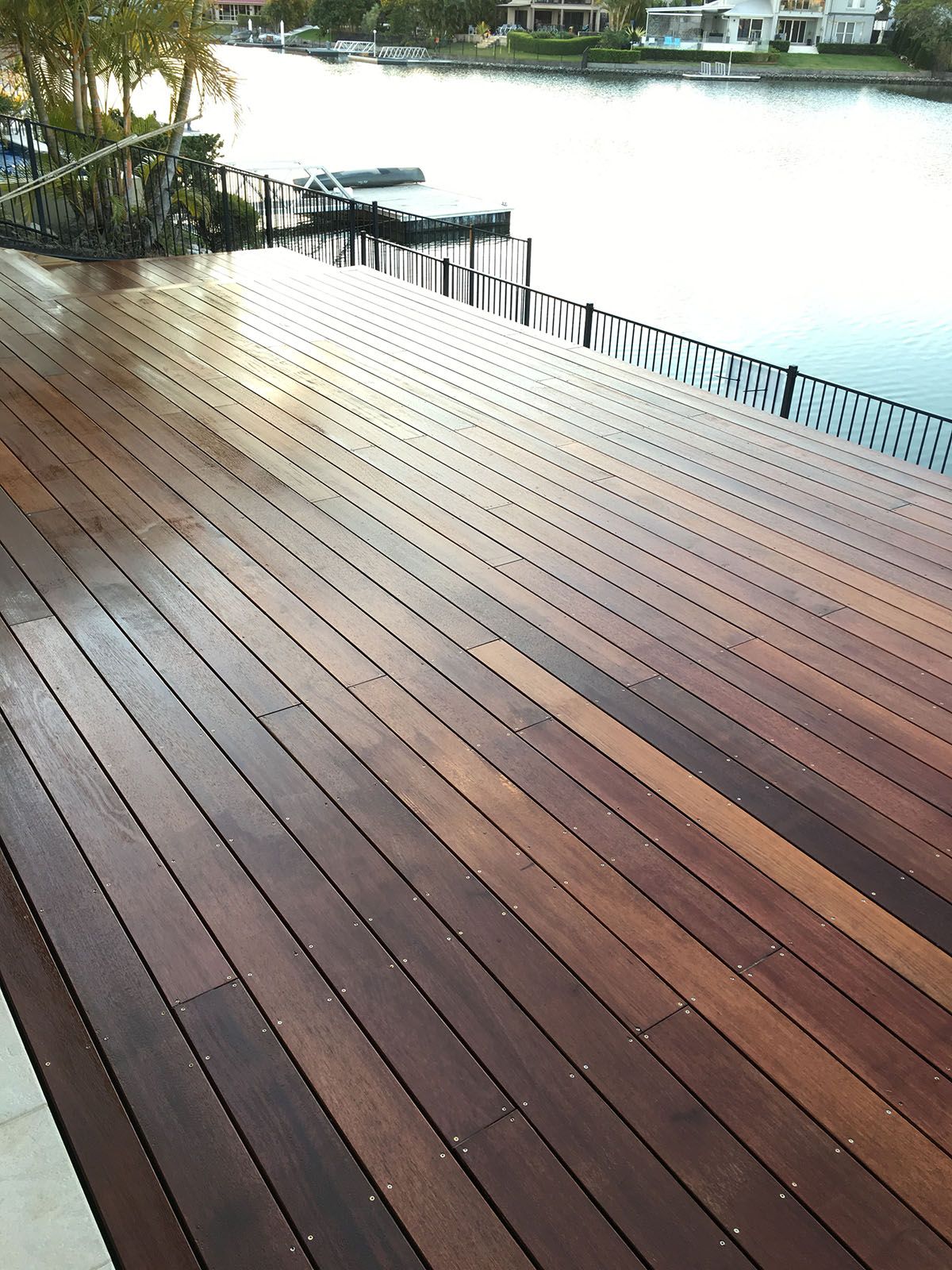 A large wooden deck overlooking a body of water