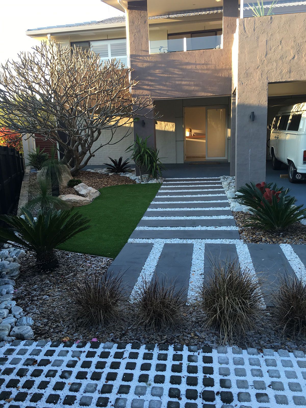 A house with a white van parked in front of it