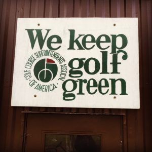 Sign: "We keep golf green," with logo of Golf Course Superintendents Association of America.