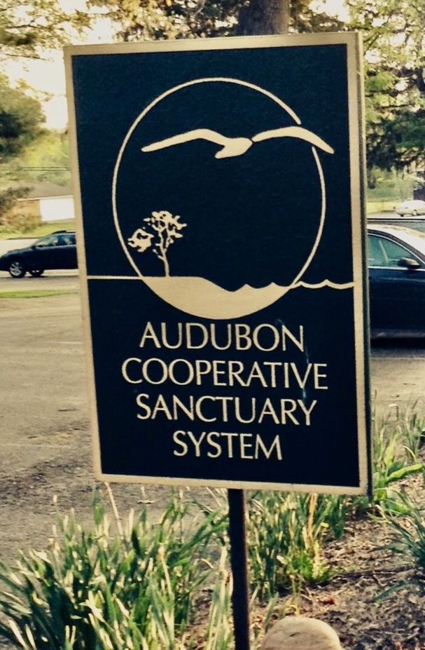 Sign for Audubon Cooperative Sanctuary System with seagull graphic.