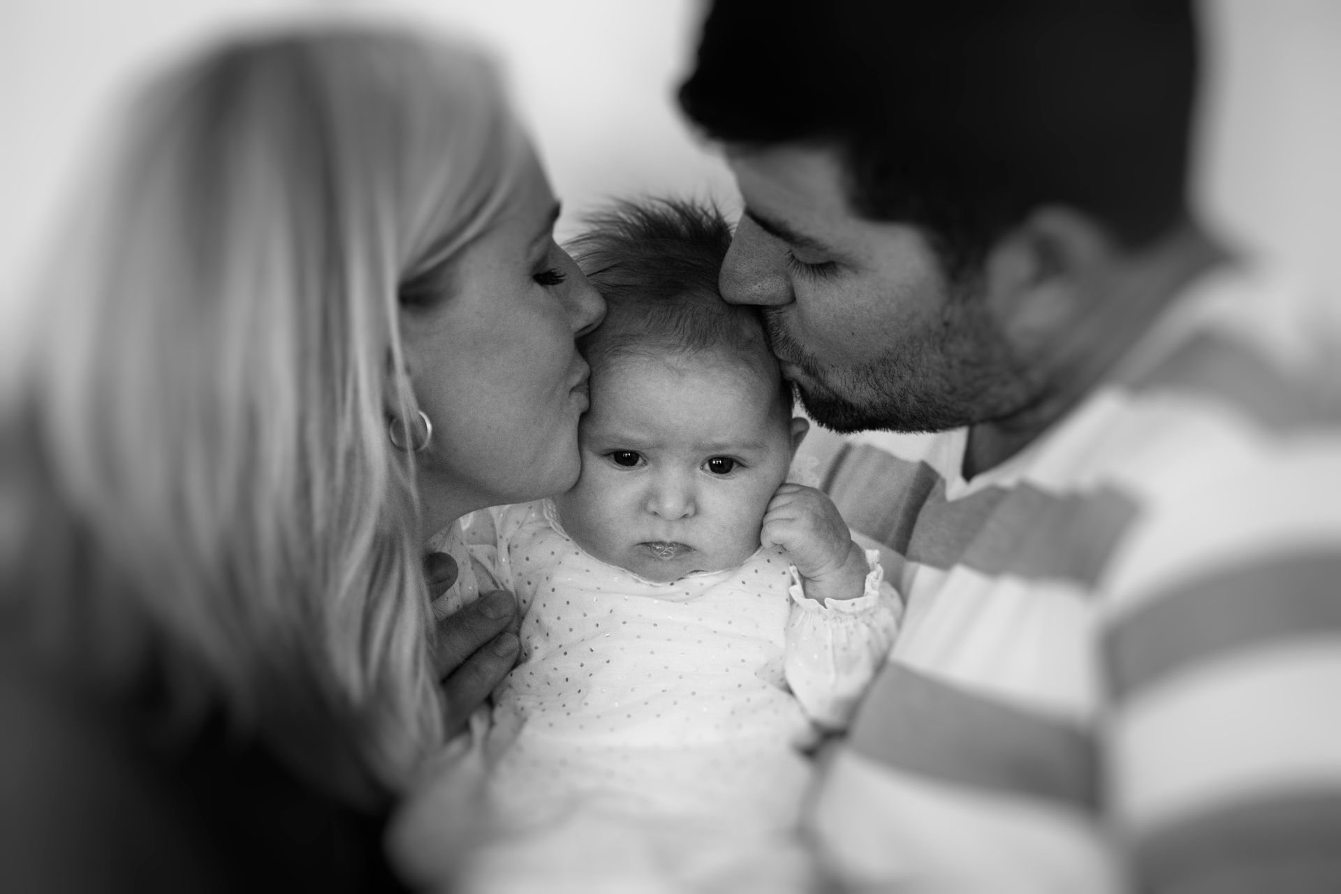 Wedding arch with floral arrangement and draped fabric against a natural backdrop.