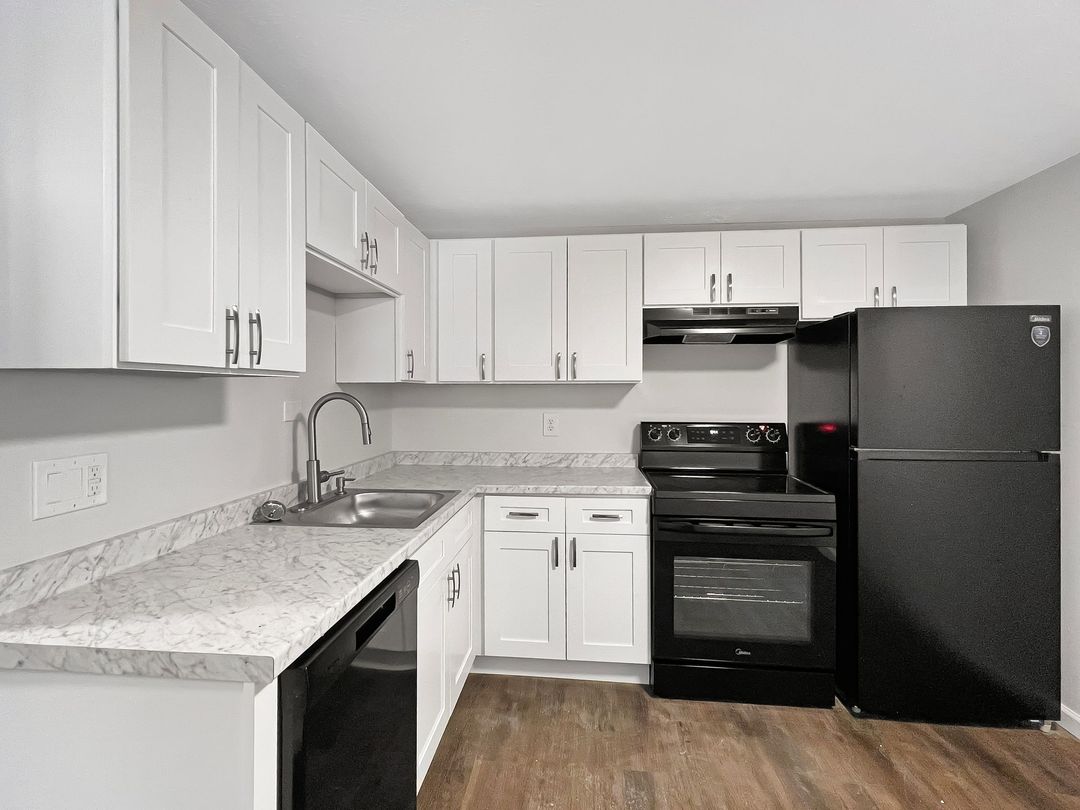 Interior Photo of 860 East Kitchen with White Cabinets and Black Appliances