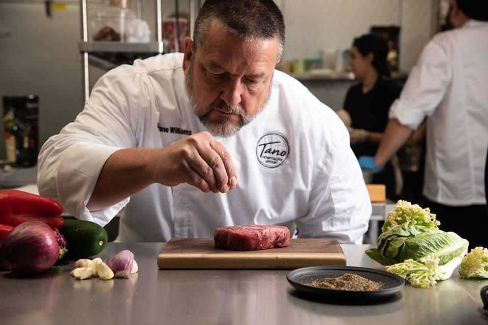 Chef preparing food at Tano Bistro kitchen counter