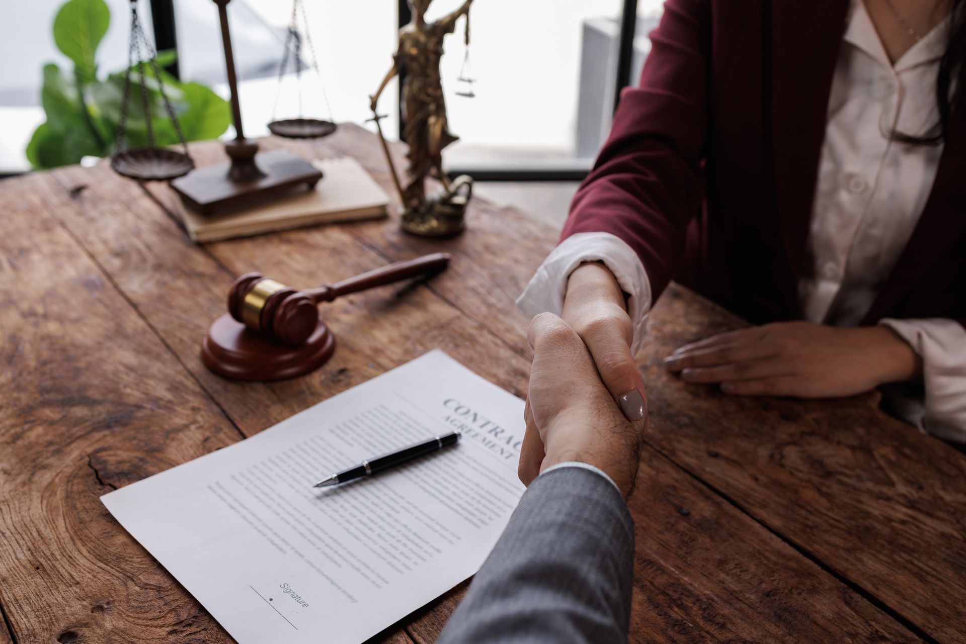 A lawyer is shaking hands with a woman.