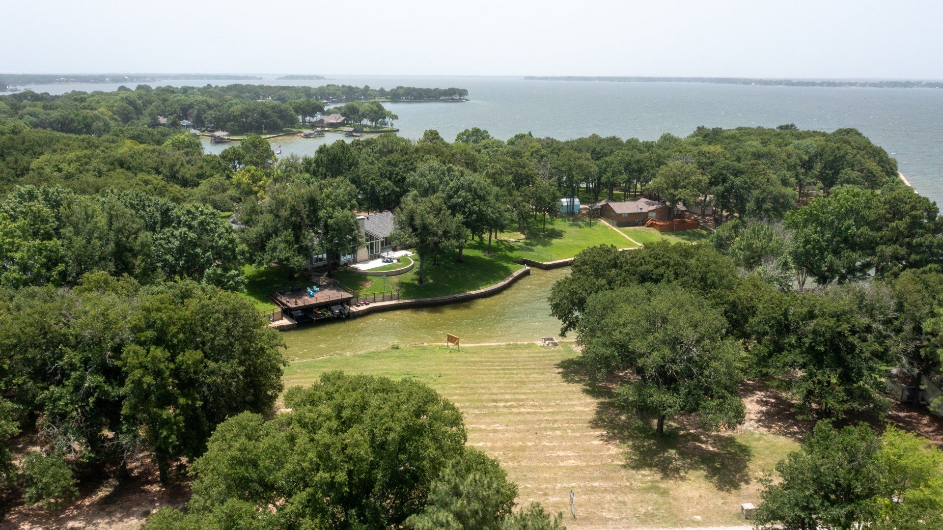 An aerial view of a large body of water surrounded by trees.