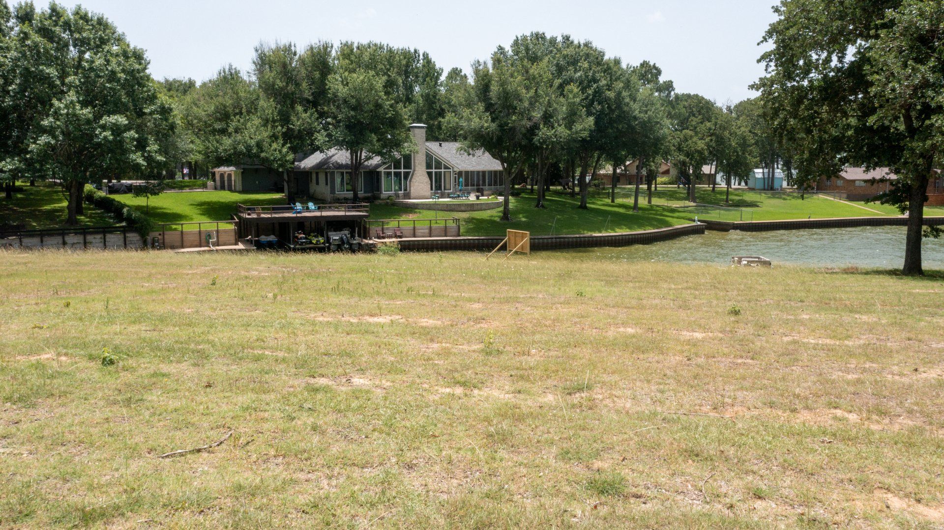 A large grassy field with a house in the background