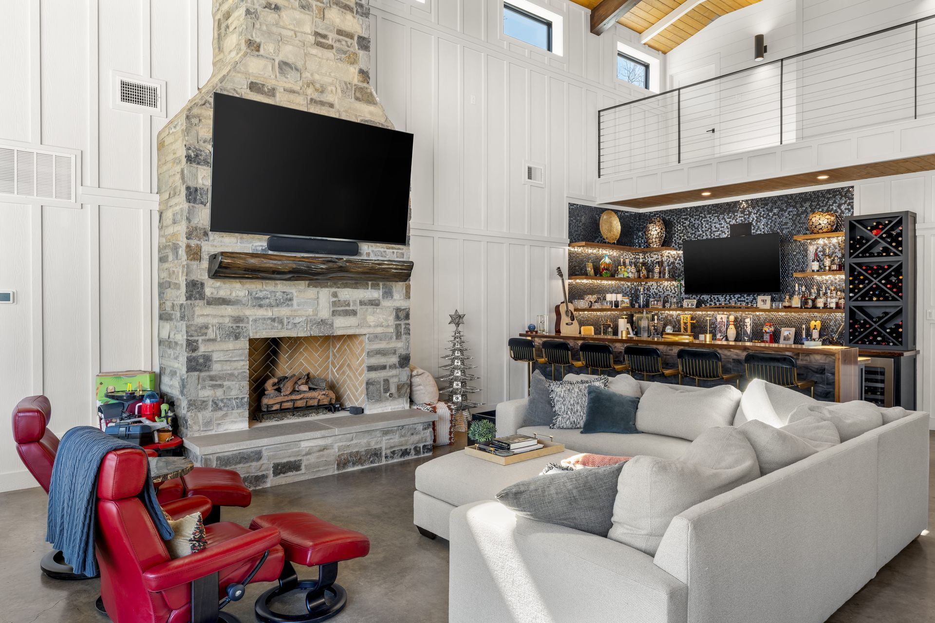 A living room with a couch , fireplace and television.