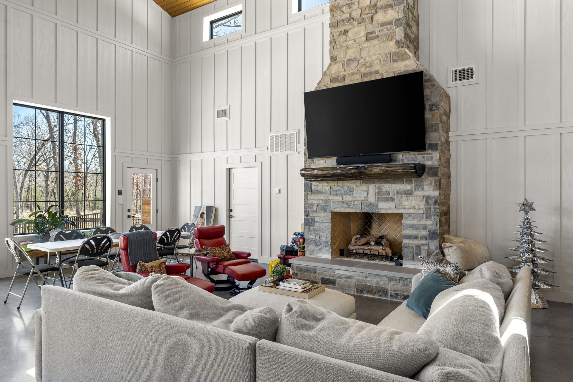 A living room with a couch , fireplace and television.