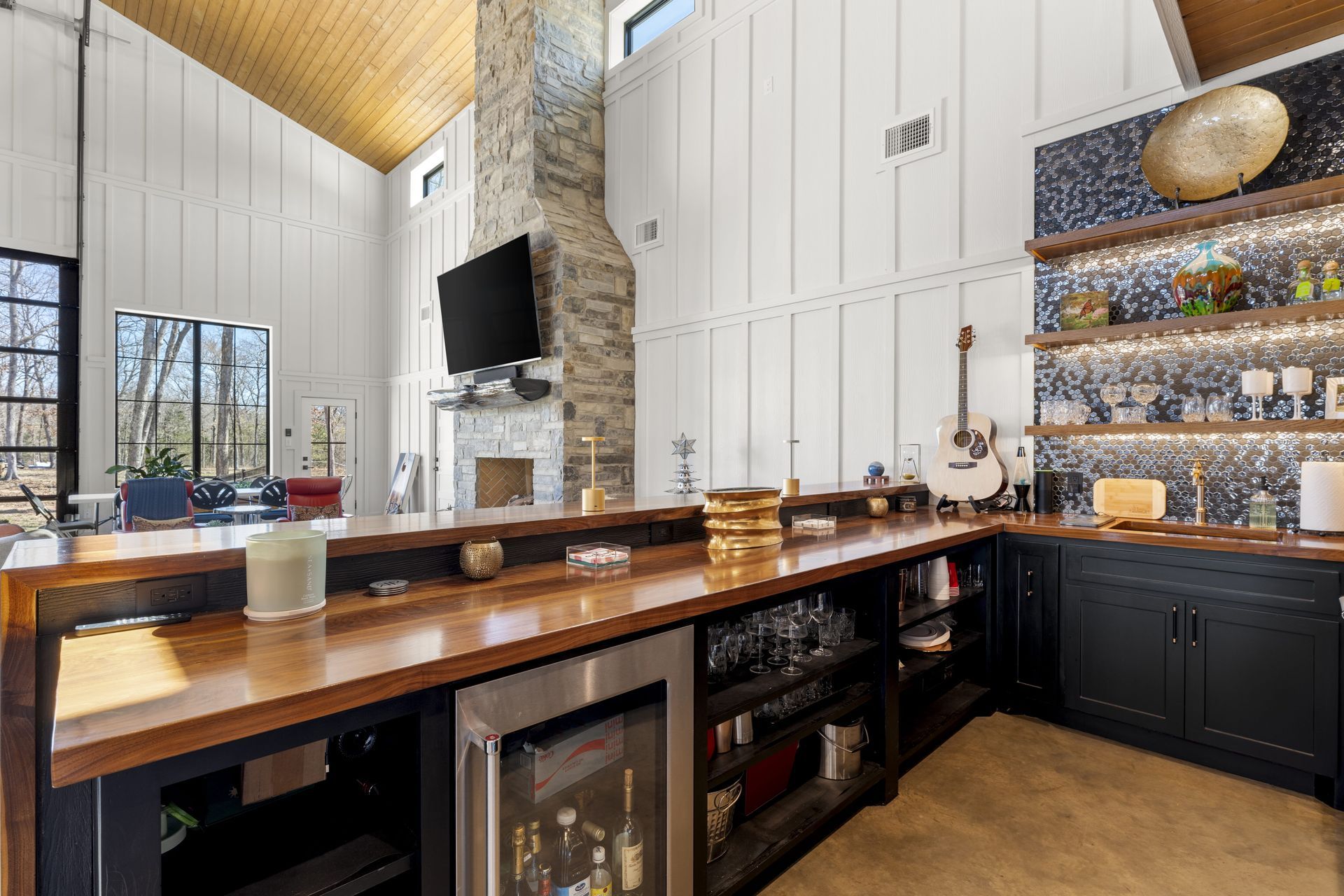 A kitchen with a long counter and a refrigerator.