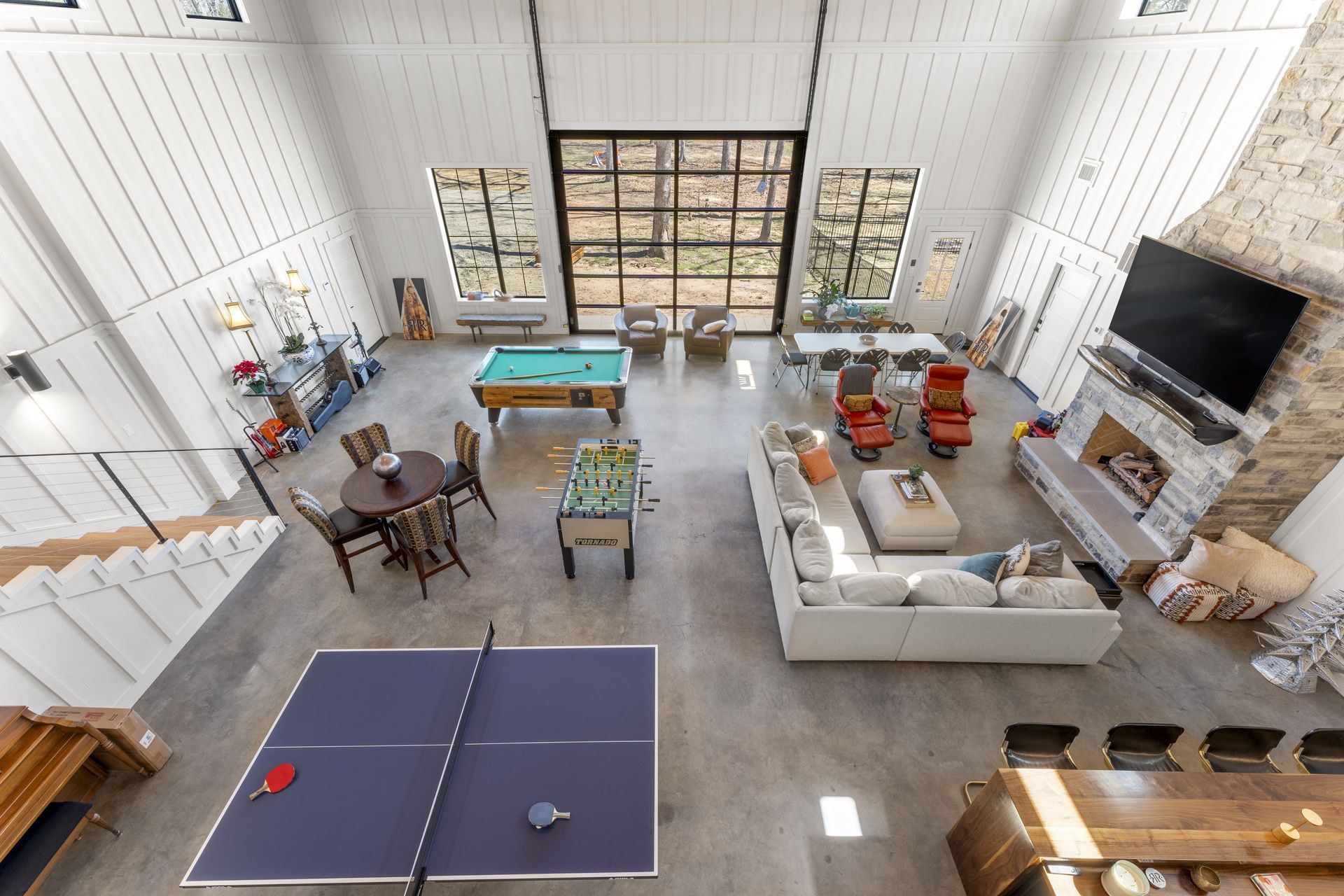 There is a ping pong table in the middle of the living room.