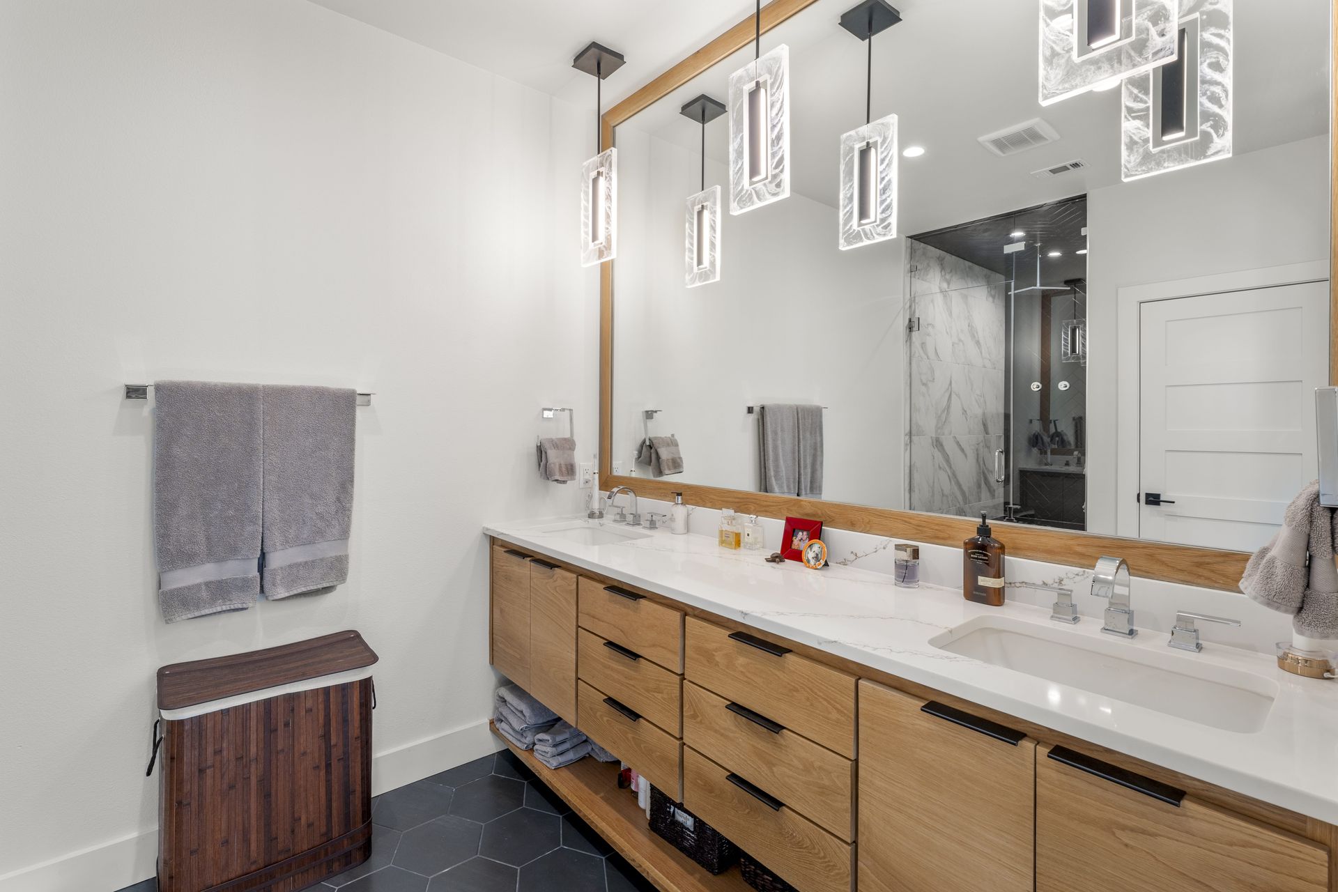 A bathroom with two sinks and a large mirror.