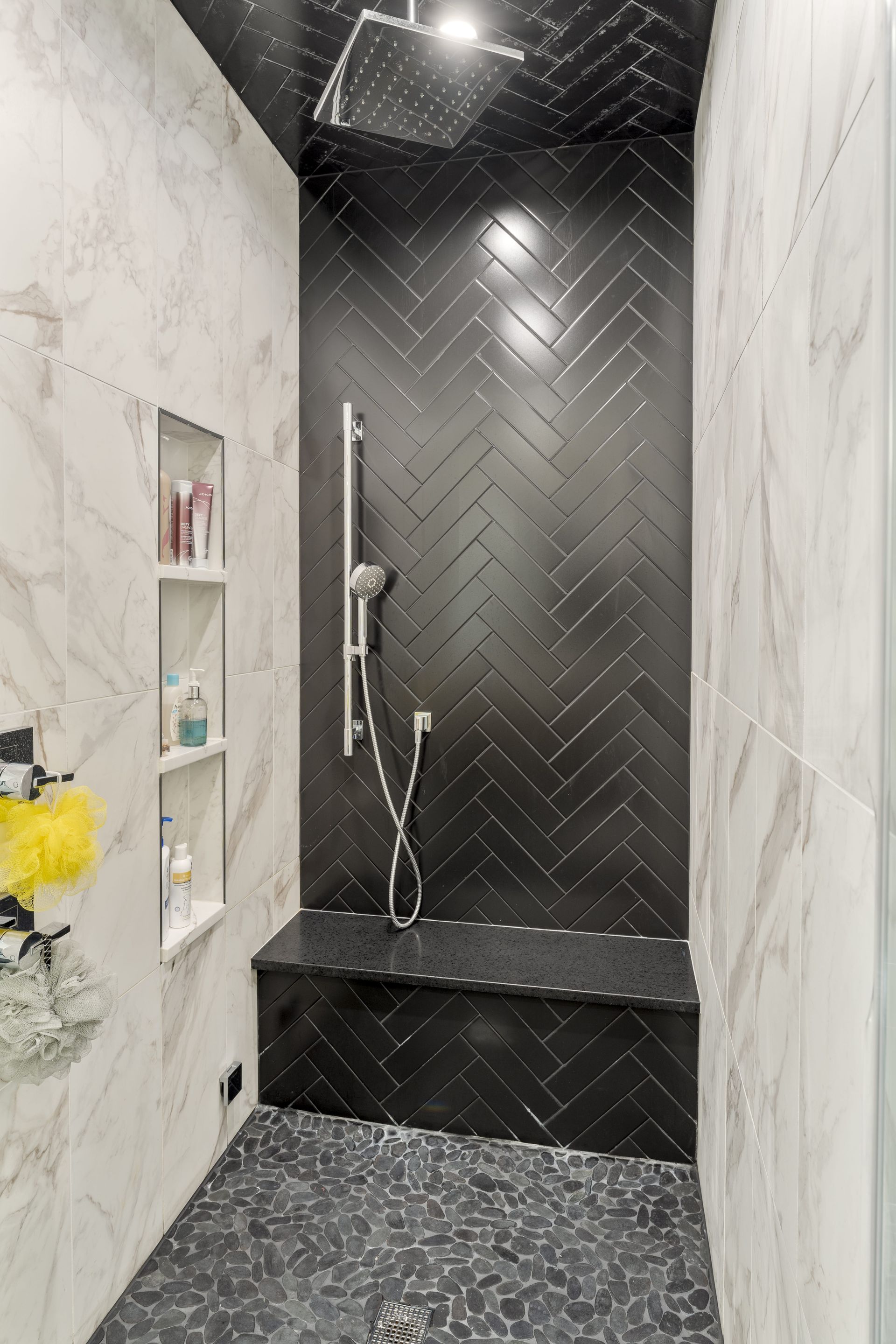 A bathroom with a shower and a bench in it.