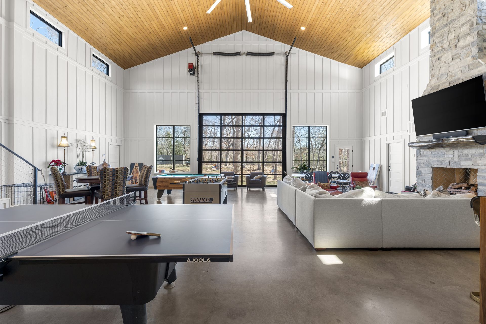 There is a ping pong table in the middle of the living room.