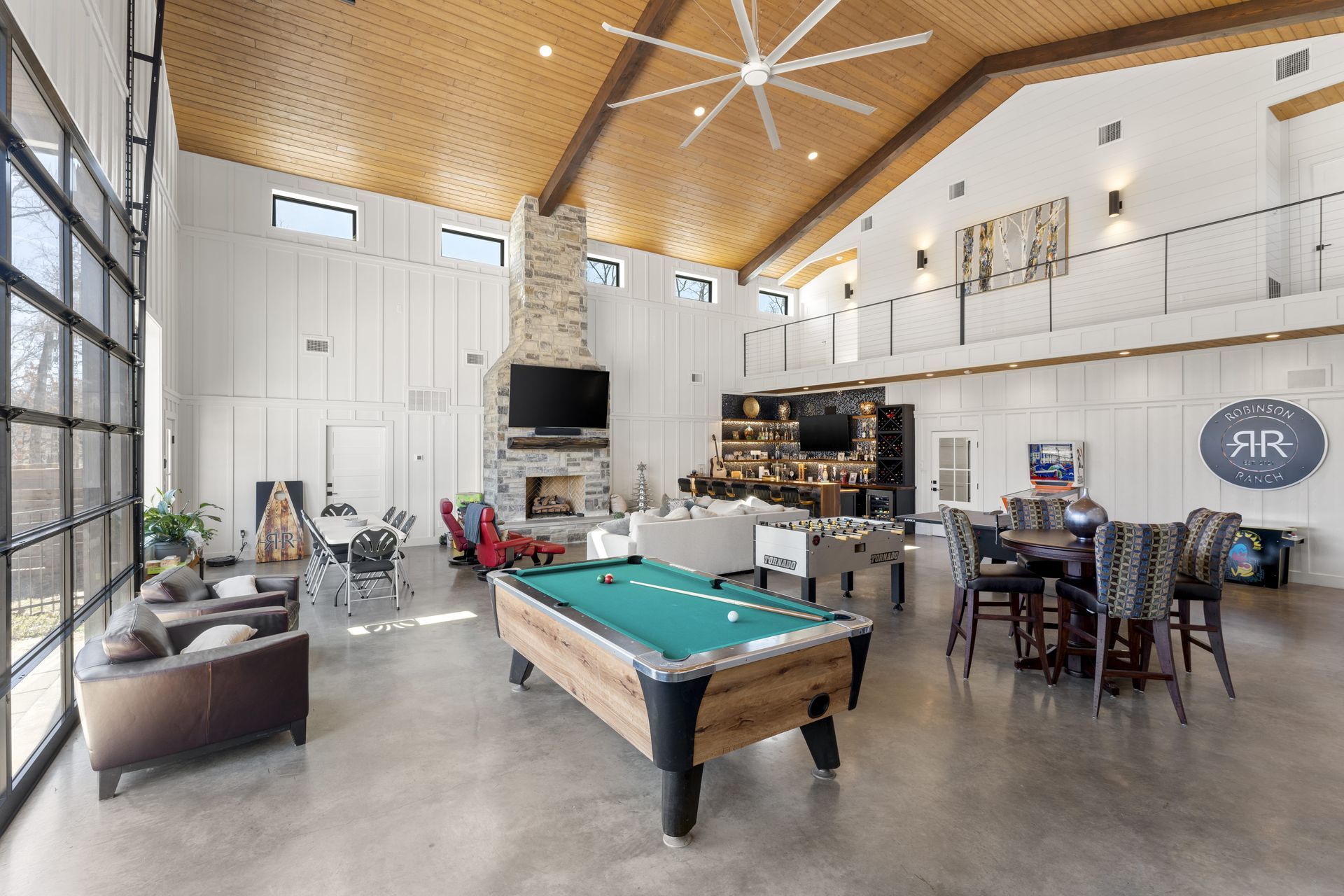 There is a pool table in the middle of the room.