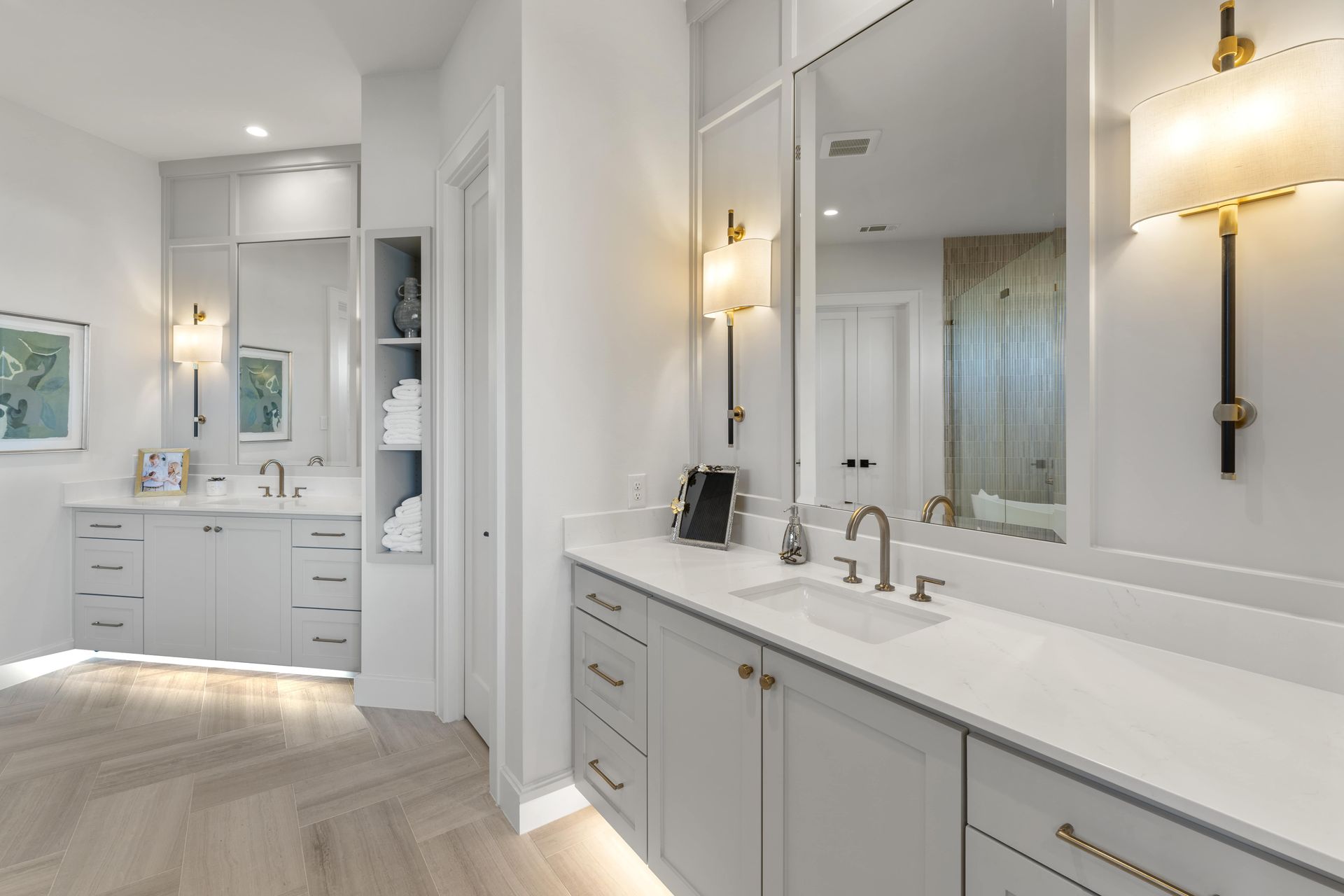 A bathroom with two sinks and a large mirror.