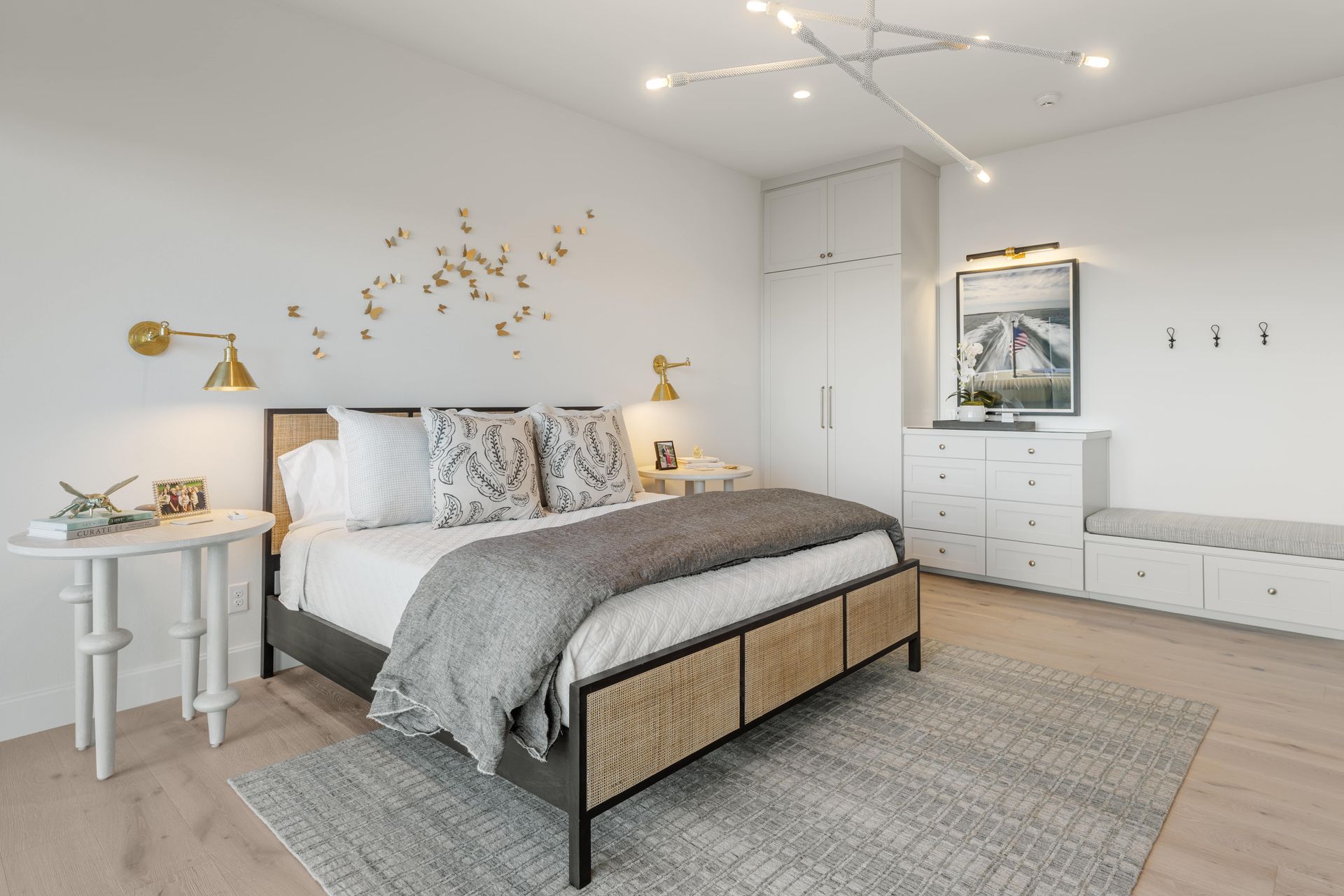 A bedroom with a bed , nightstand , dresser , and rug.