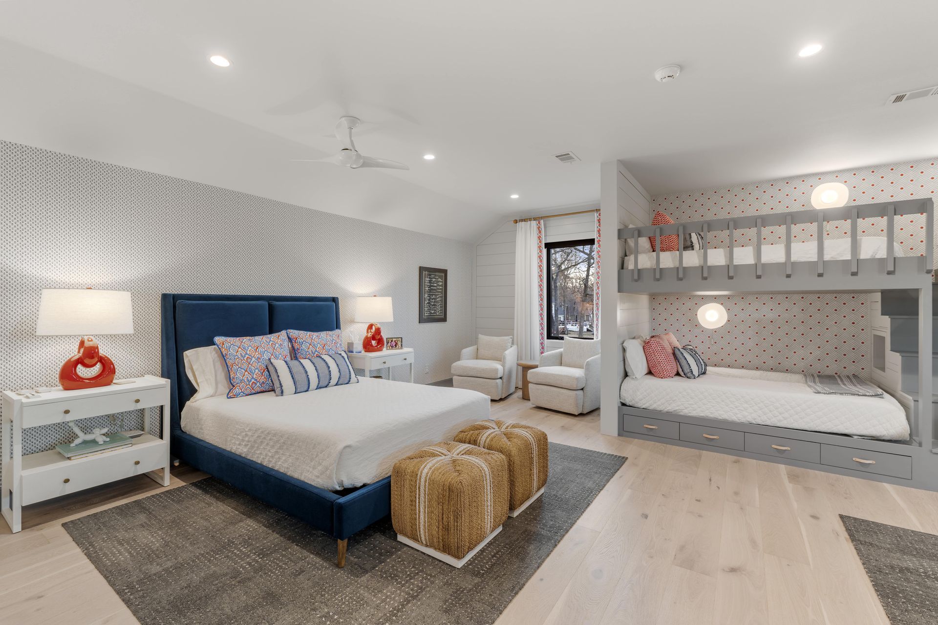 A bedroom with a king size bed and two bunk beds.