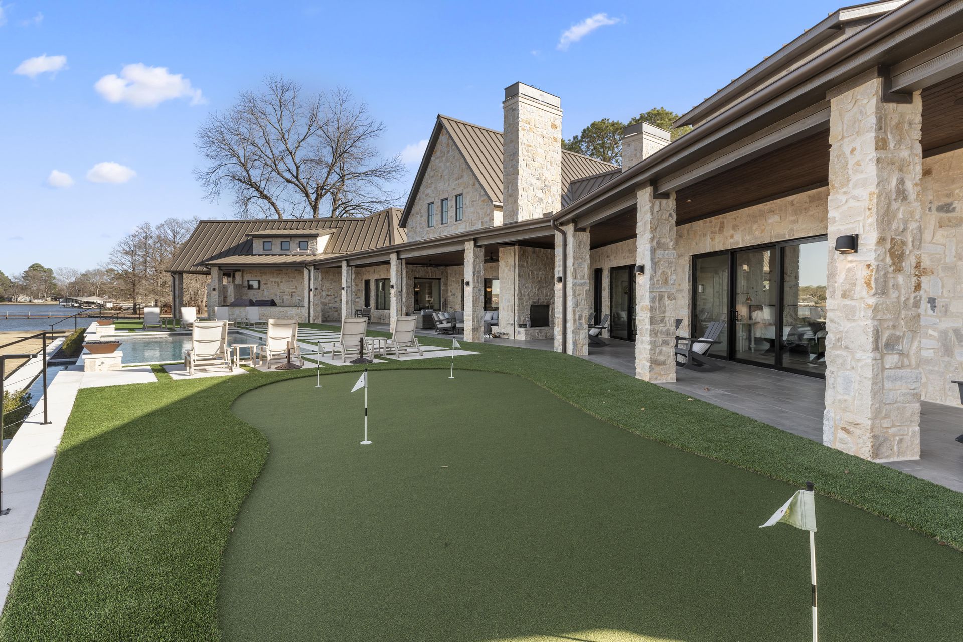 A large house with a putting green in front of it