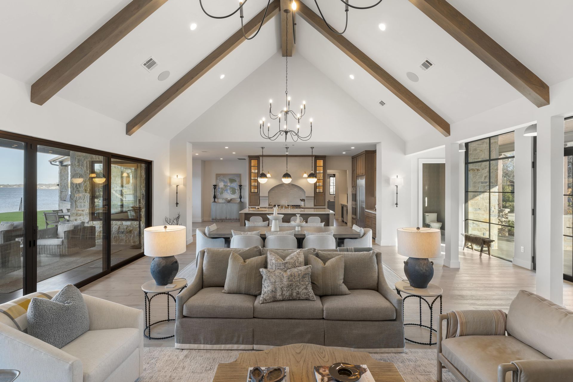 A living room filled with furniture and a vaulted ceiling.