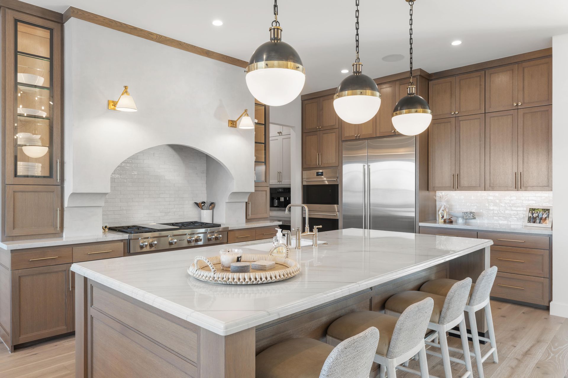 A kitchen with a large island and stainless steel appliances.