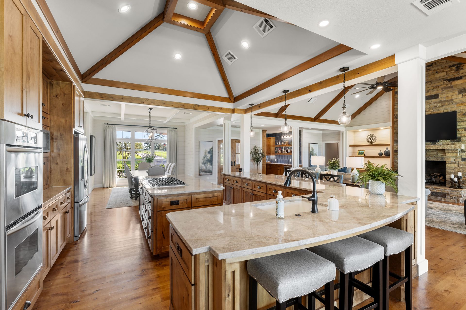 A large kitchen with a large island and stools.