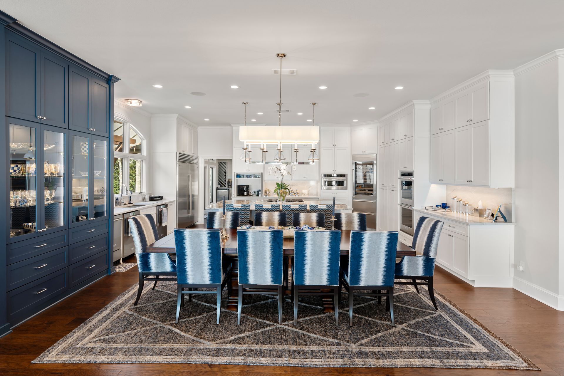 A kitchen with white cabinets and stainless steel appliances.
