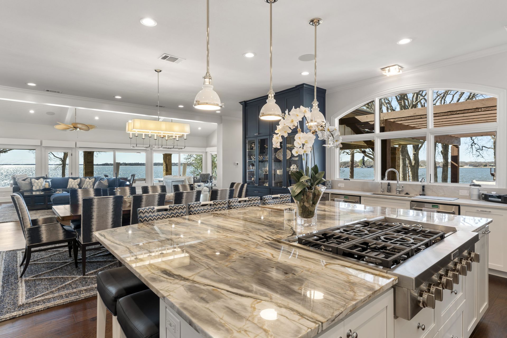 A kitchen with a large island and a stove top oven.