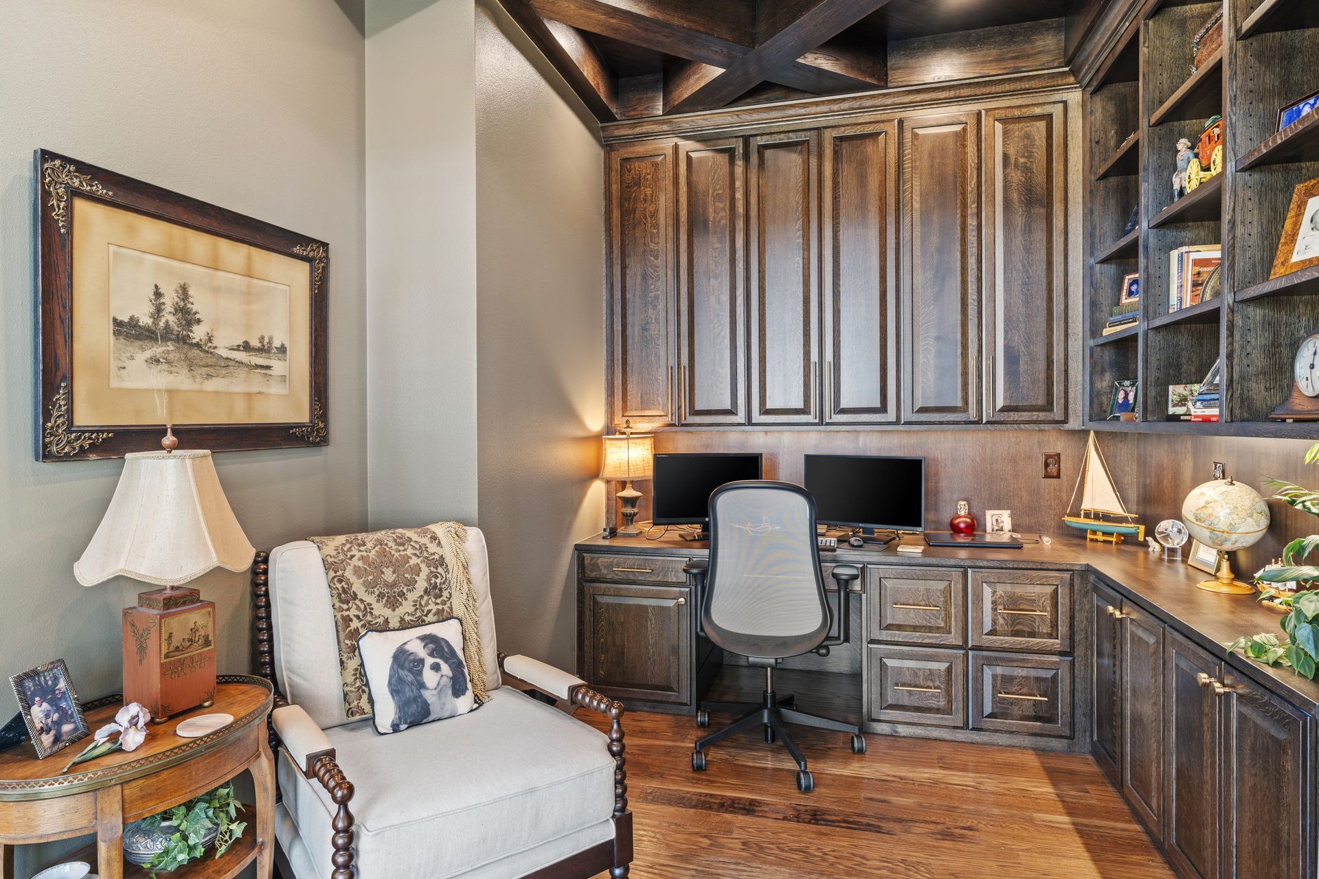 A home office with a chair , desk , computer and shelves.