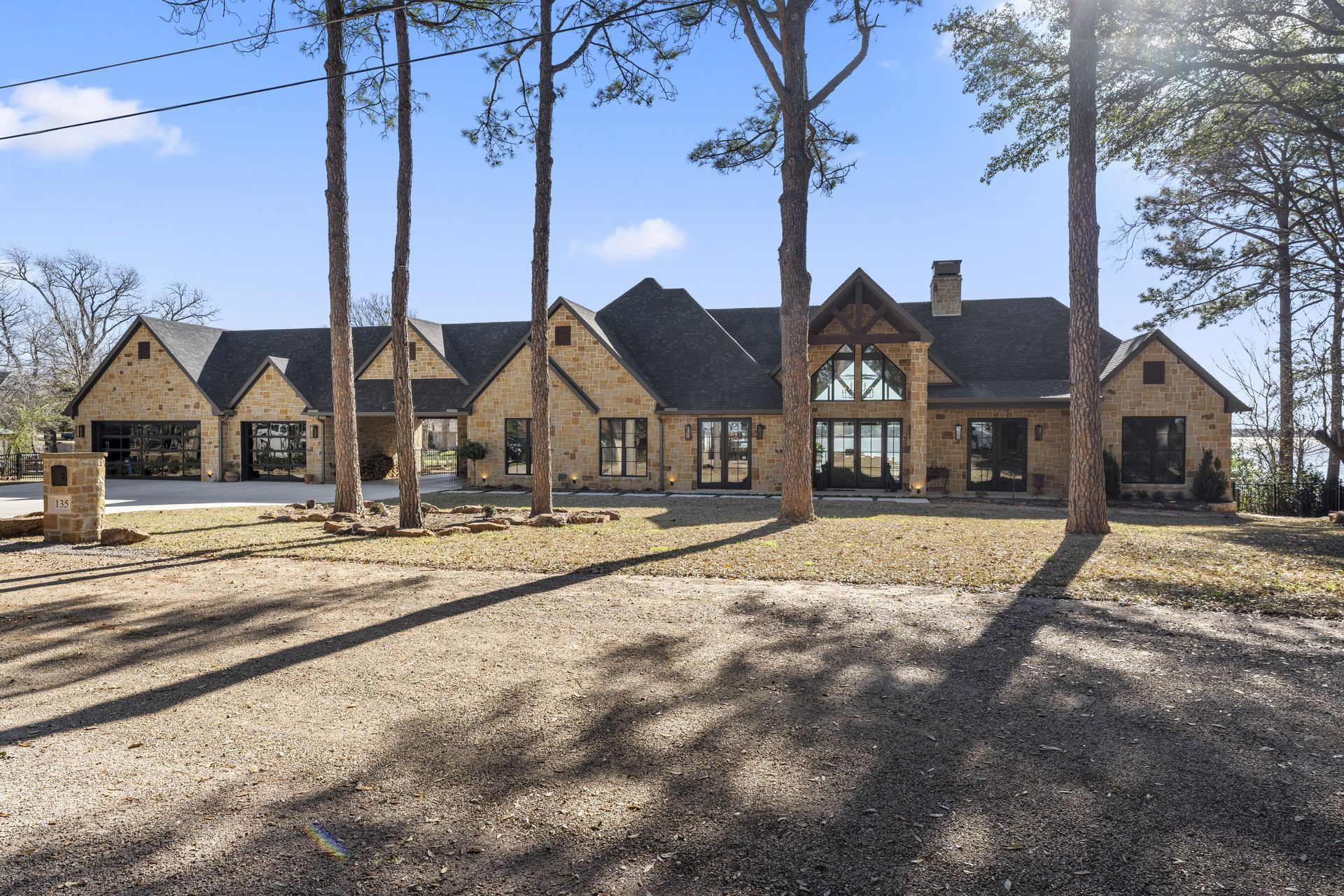 A large house with a lot of windows is surrounded by trees
