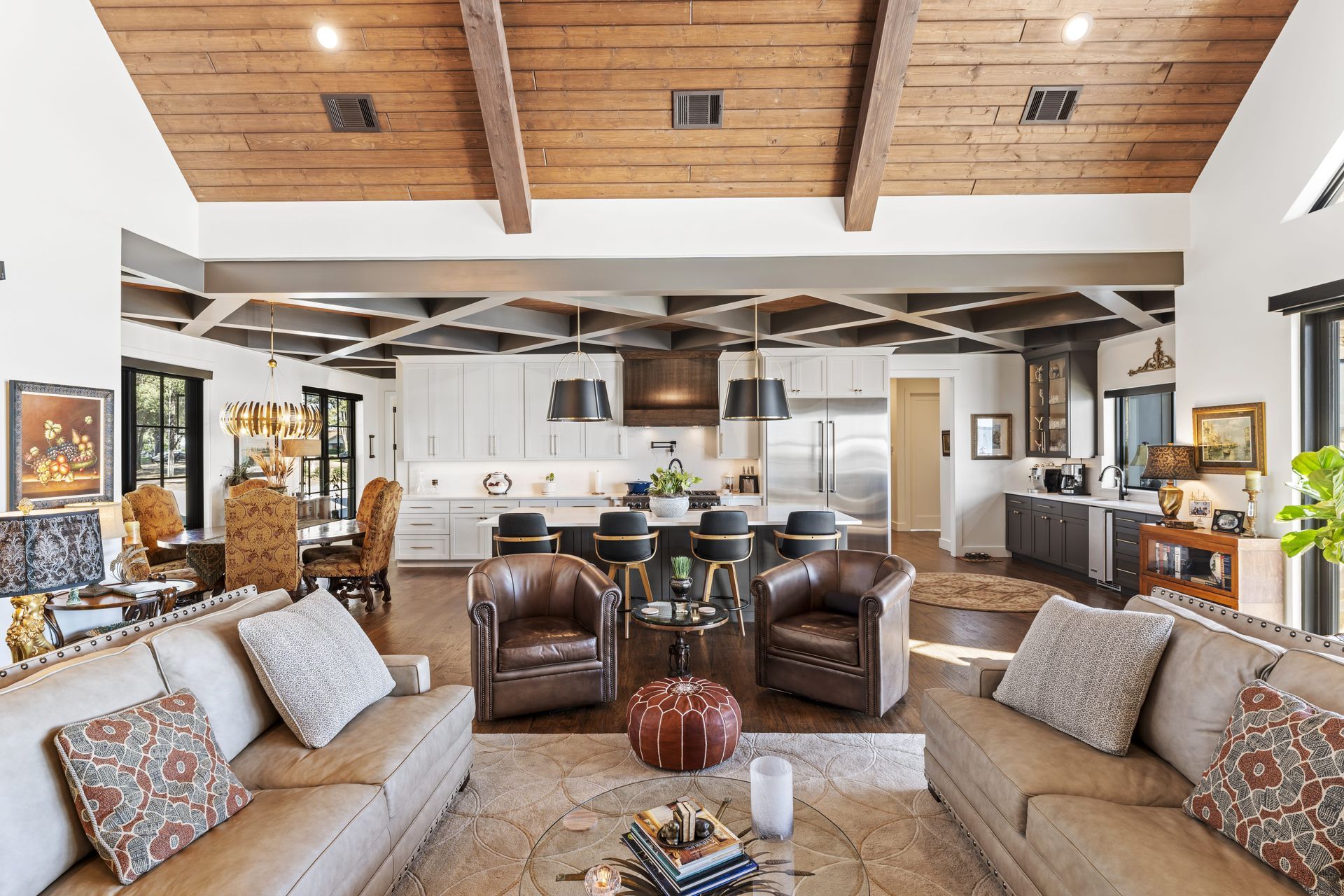 A living room filled with furniture and a wooden ceiling