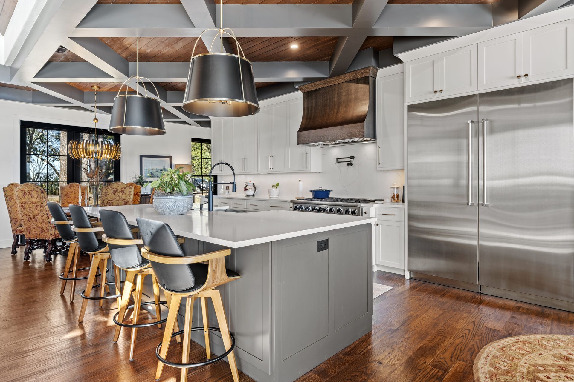 A kitchen with stainless steel appliances and a large island.