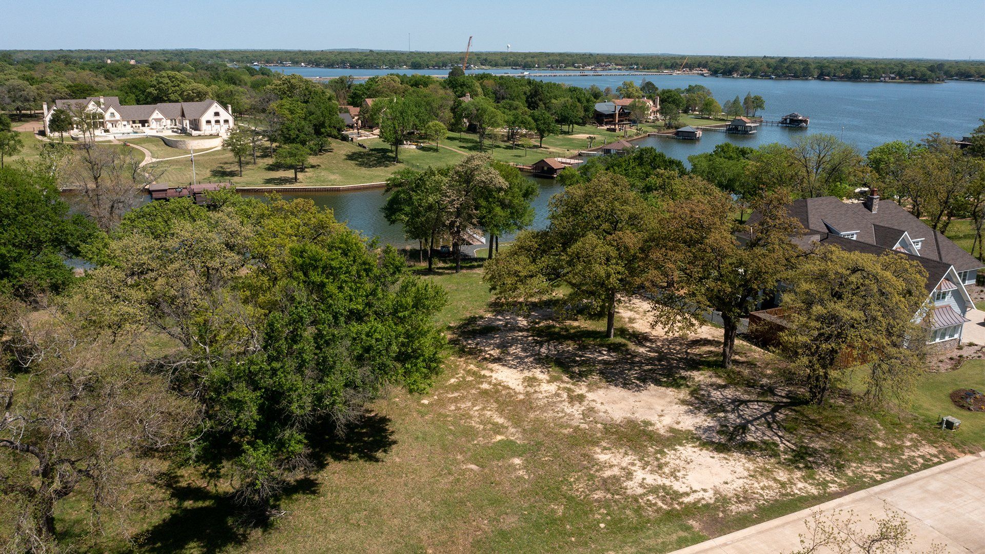 An aerial view of a residential area with a lake in the background
