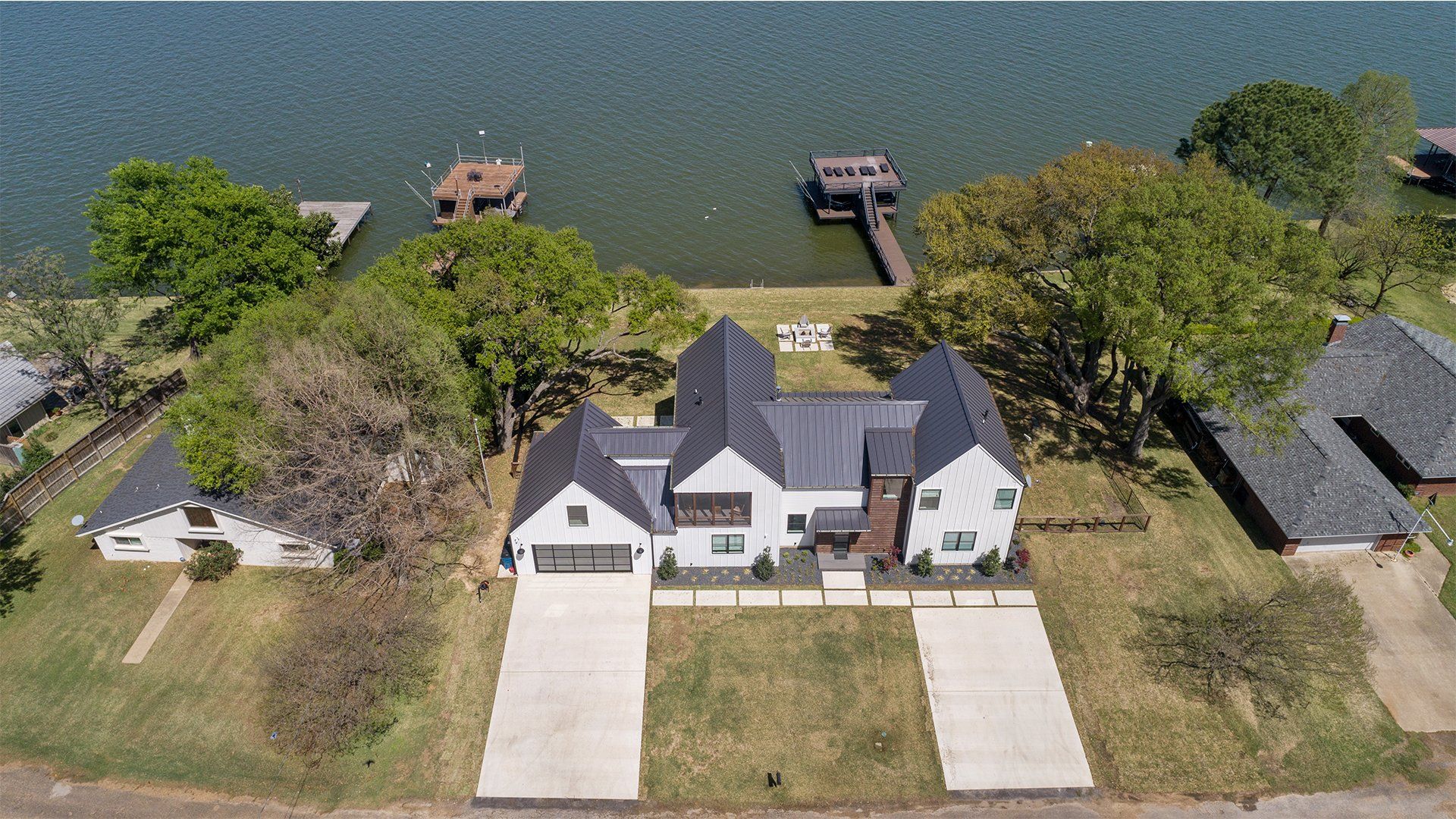 An aerial view of a house next to a lake.