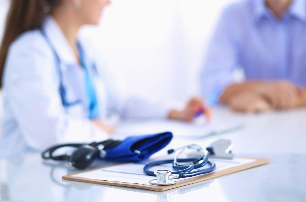 Doctor in White Coat Consults Patient — Mount Archer Medical Centre in Berserker, QLD