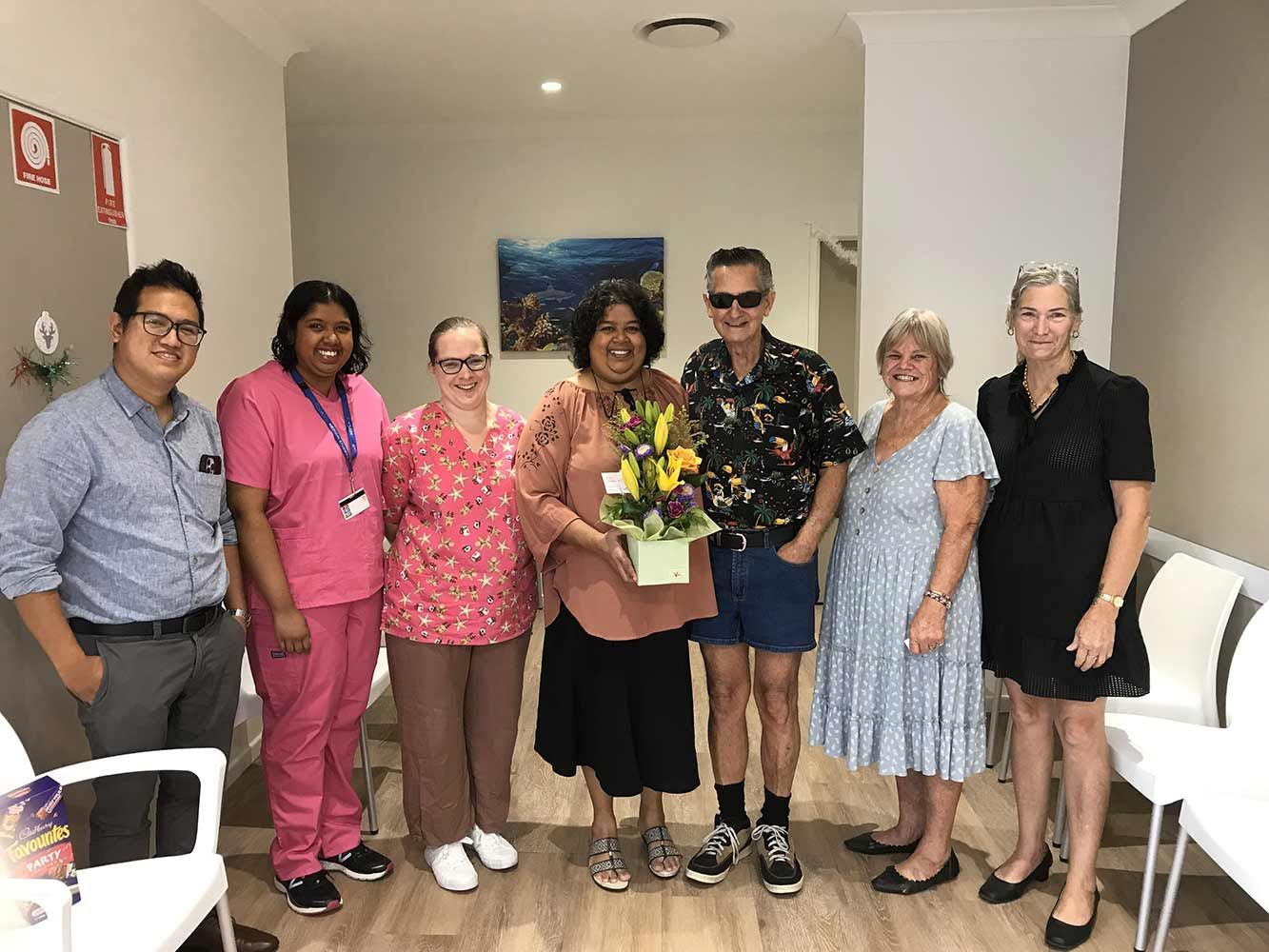 A Group of People Are Posing for a Picture in a Waiting Room — Mount Archer Medical Centre in Berserker, QLD