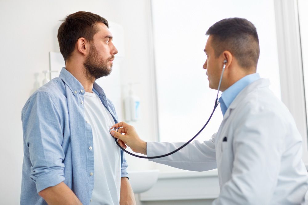 A Doctor is Listening to a Patient 's Heart With a Stethoscope — Mount Archer Medical Centre in Berserker, QLD